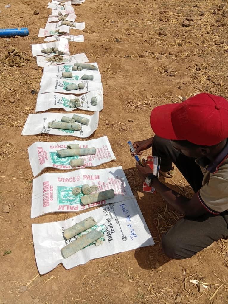 Drill core samples bagged, labelled, and laid out in sequence for logging.